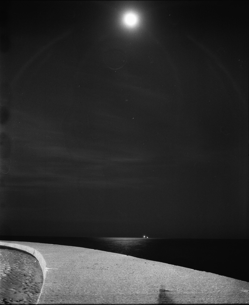 the moon over curved jetty