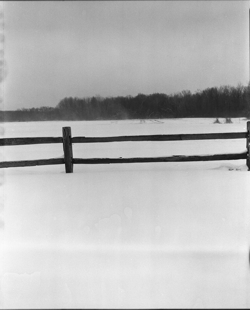 Fence in a Snowy Field