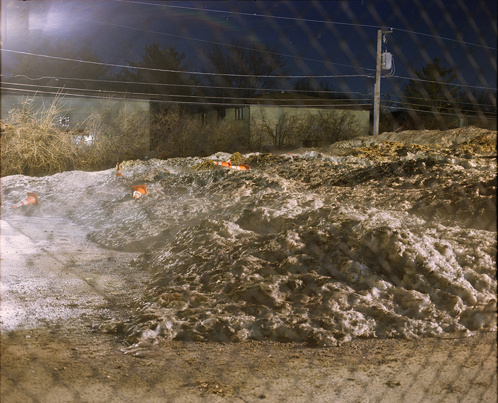 Snow Pile and Cones behind Fence