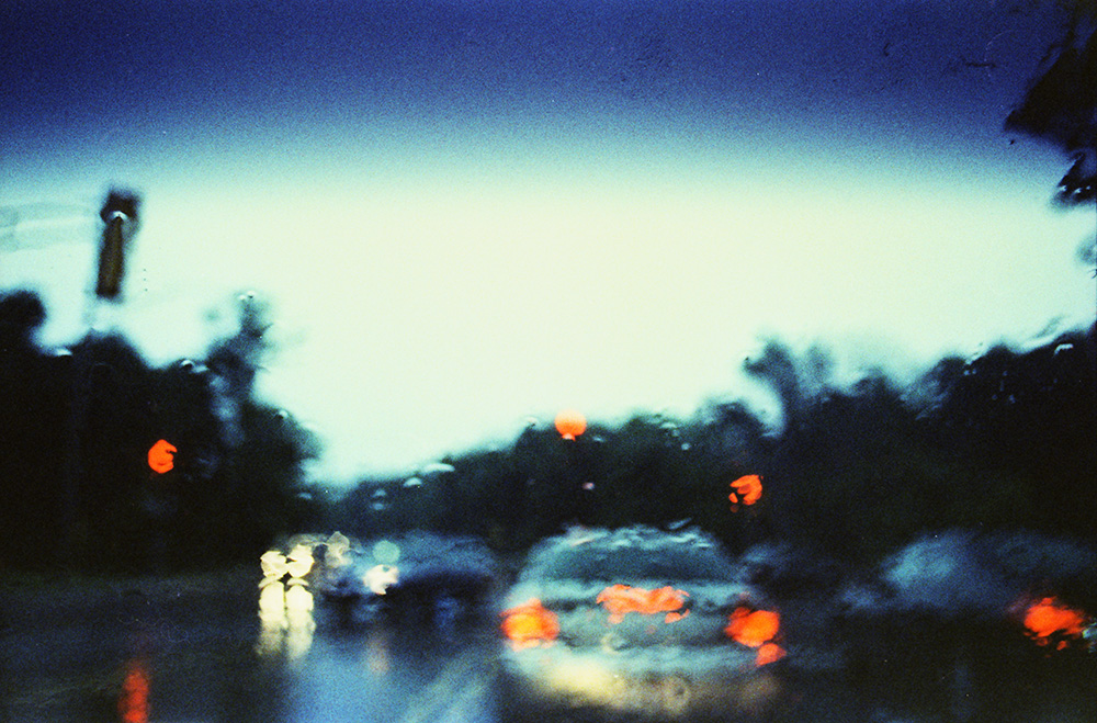 Rain Distorting Traffic at a Red Light
