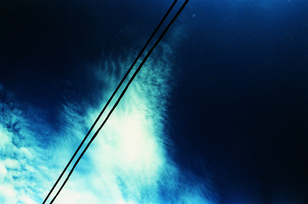 Powerlines Bisecting Clouds and Sky