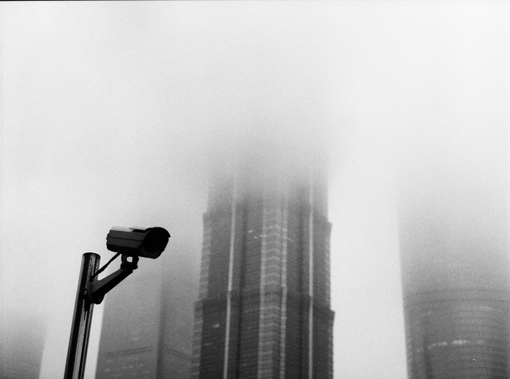 Camera and Foggy Buildings